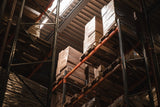 Stacks of wooden pallets in a warehouse setting